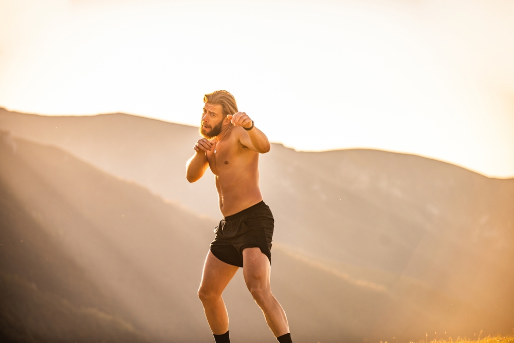 Does Shadow Boxing Build Muscle Muscleandstrong Com   Man Boxing With Shadow Exercising At Sunset Outdoor 